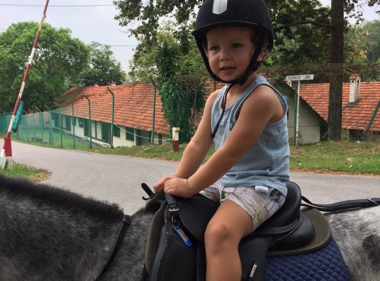 Little boy horse riding in Singapore