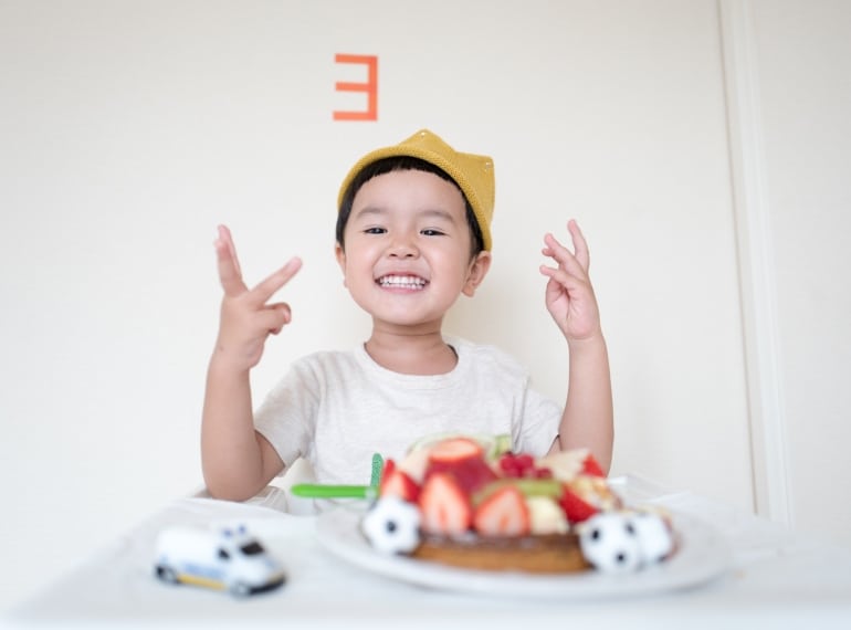 Young boy celebrating his birthday with cake