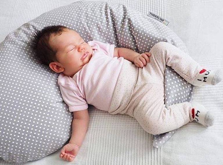 Baby sleeping outlet on breastfeeding pillow