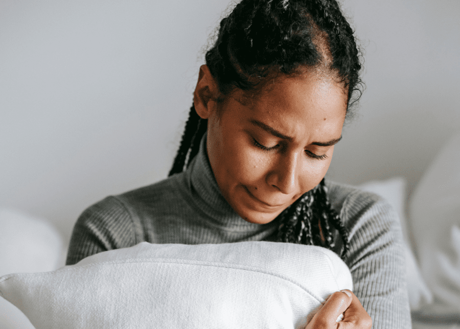 caregiver burnout woman hugging pillow